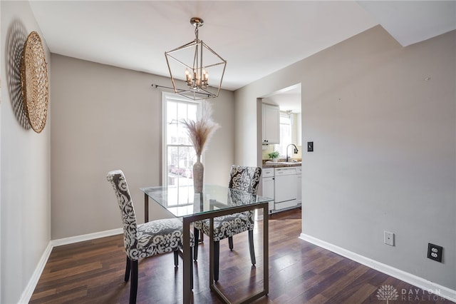 dining area with baseboards, dark wood finished floors, and a chandelier