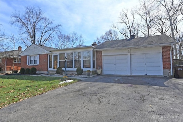 ranch-style home with a garage and a front yard