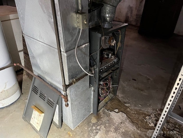 utility room featuring gas water heater