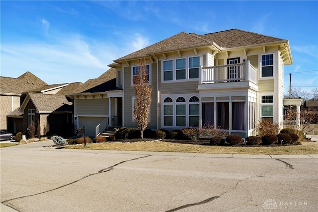 view of front of property with a garage and a balcony