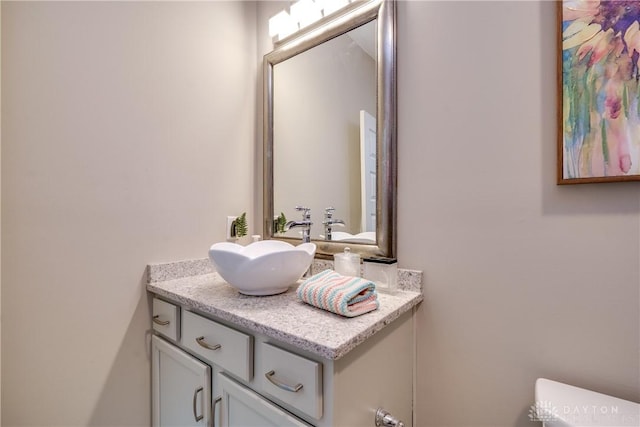 bathroom with toilet and vanity