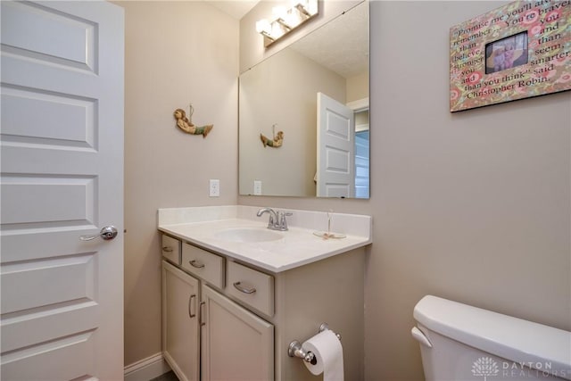 bathroom featuring toilet and vanity