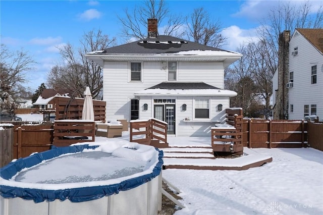 snow covered property featuring a covered pool