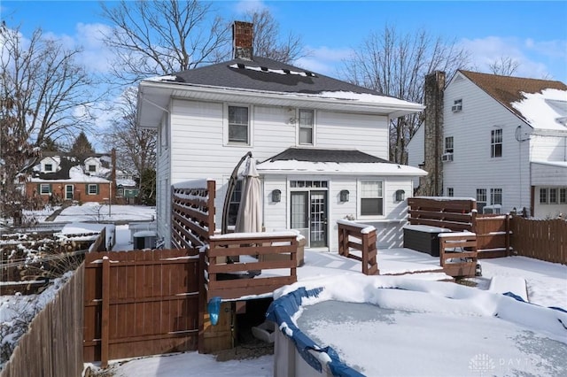 view of snow covered rear of property