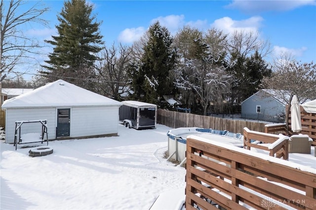 yard covered in snow with an outdoor structure