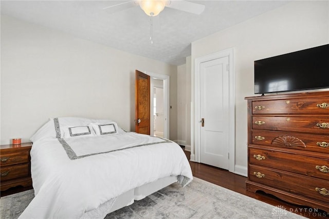 bedroom with dark wood-type flooring and ceiling fan