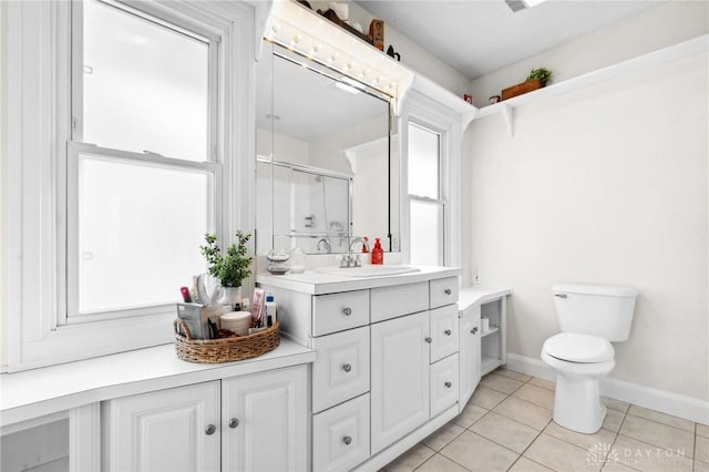 bathroom with vanity, toilet, tile patterned floors, and walk in shower