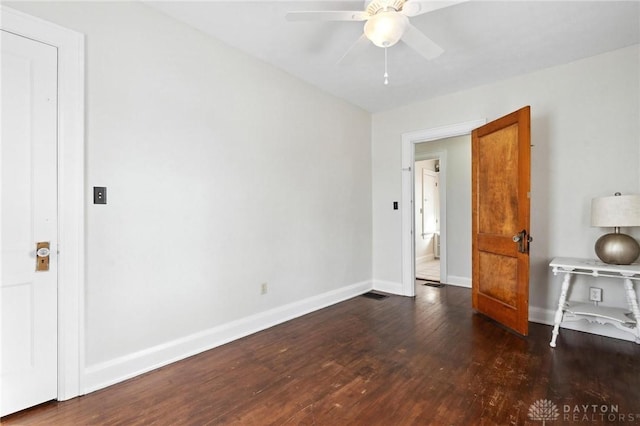 unfurnished bedroom featuring ceiling fan and dark hardwood / wood-style flooring