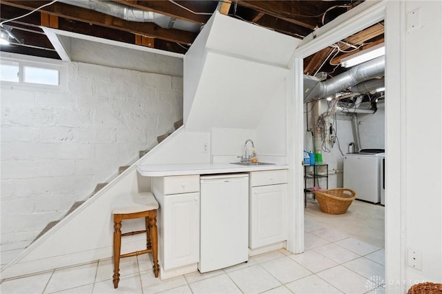 basement with sink and washer / dryer