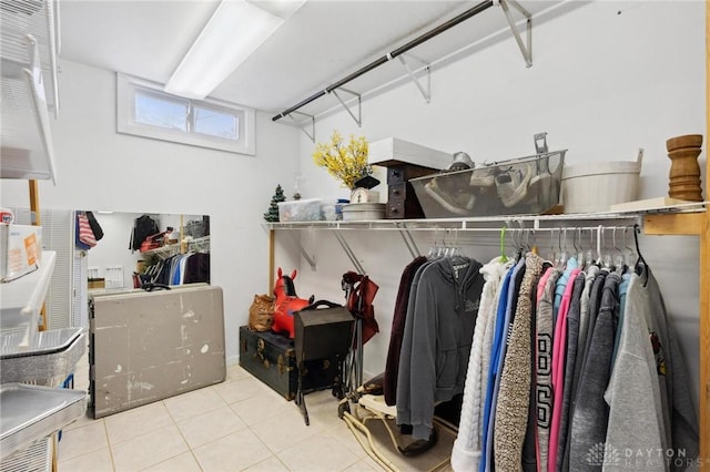 walk in closet with light tile patterned floors