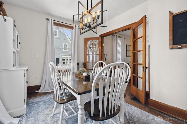 dining room featuring a chandelier and dark hardwood / wood-style floors