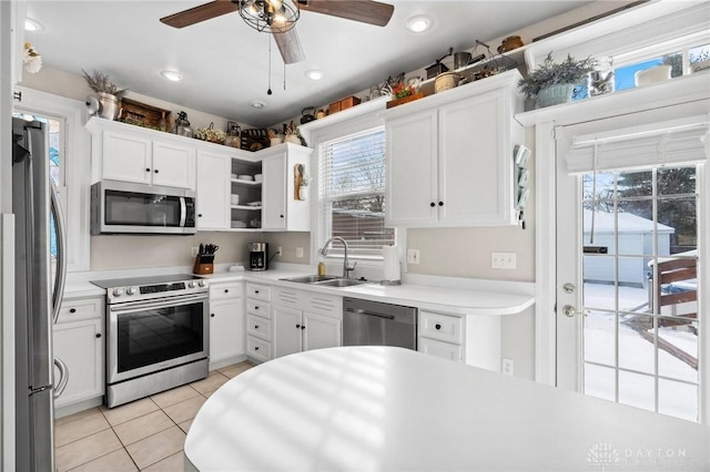 kitchen with sink, white cabinetry, and stainless steel appliances