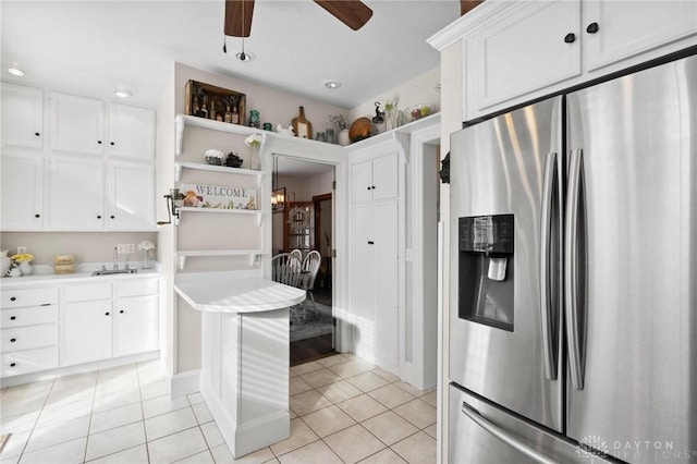 kitchen with white cabinetry, stainless steel refrigerator with ice dispenser, and light tile patterned floors