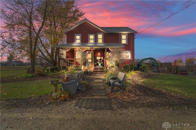 view of front of home with a yard and a porch