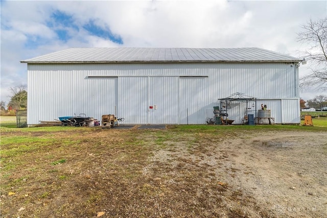 view of outbuilding with a yard