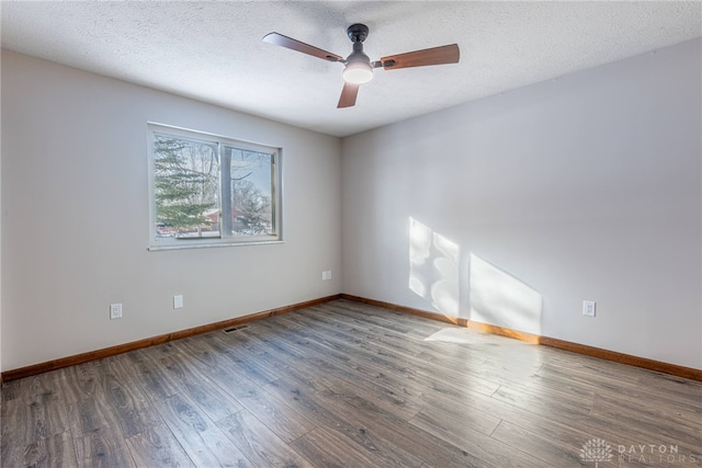 unfurnished room featuring ceiling fan, wood-type flooring, and a textured ceiling