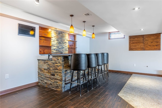 bar featuring hanging light fixtures