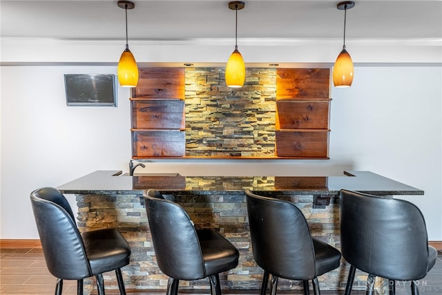 bar featuring hanging light fixtures