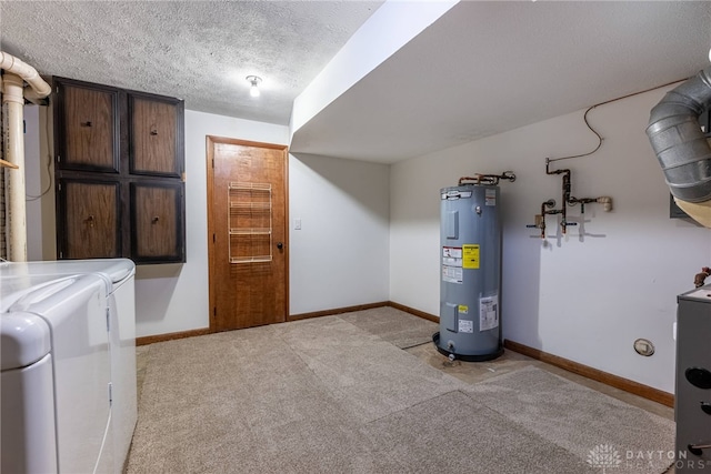 utility room with electric water heater and washer and clothes dryer