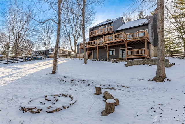 snow covered property featuring a deck