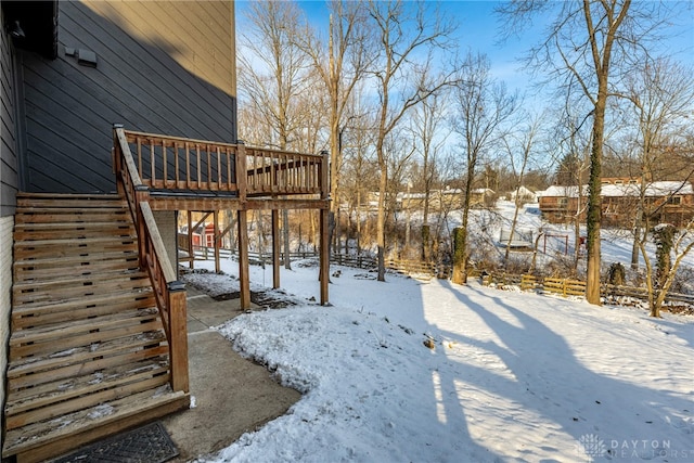 yard layered in snow with a deck