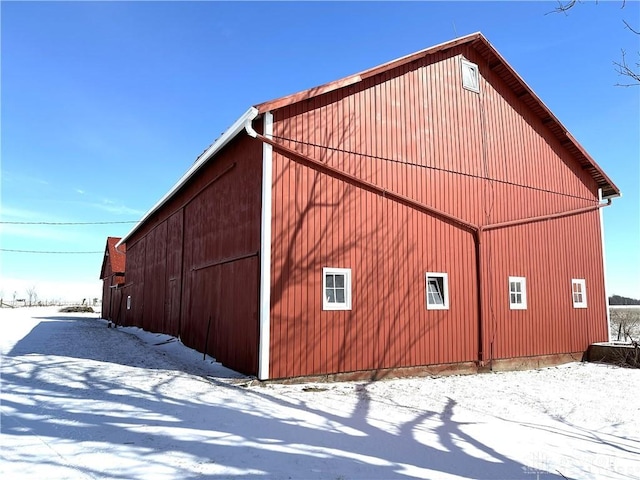 view of snow covered exterior with an outbuilding