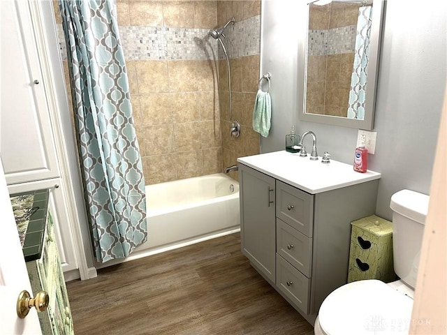 full bathroom featuring shower / tub combo with curtain, vanity, toilet, and hardwood / wood-style flooring