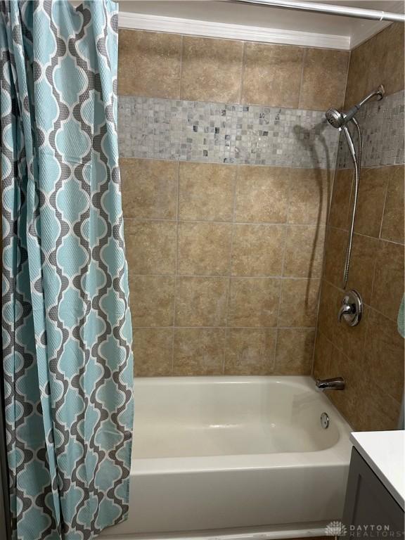 bathroom with shower / bath combination with curtain and vanity