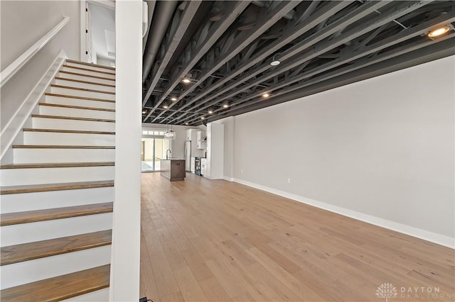 basement with hardwood / wood-style floors