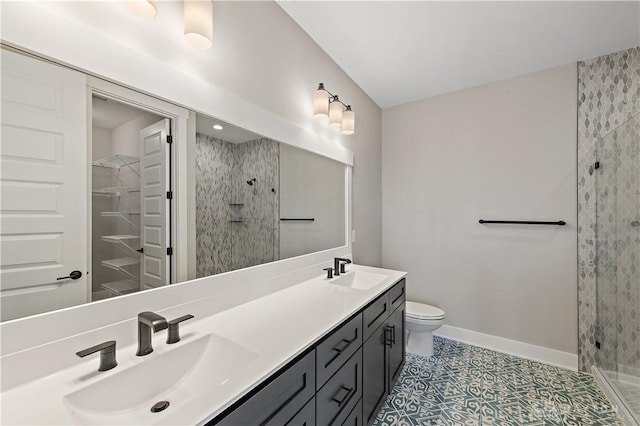 bathroom with vanity, tile patterned flooring, toilet, and walk in shower