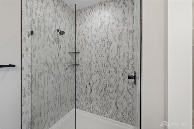 bathroom with tiled shower