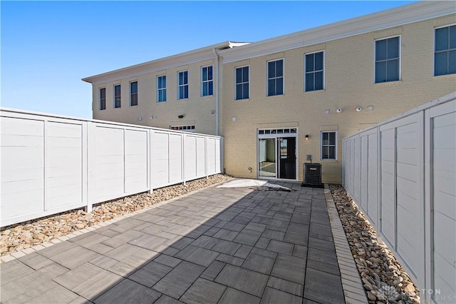 rear view of property with a patio and central air condition unit