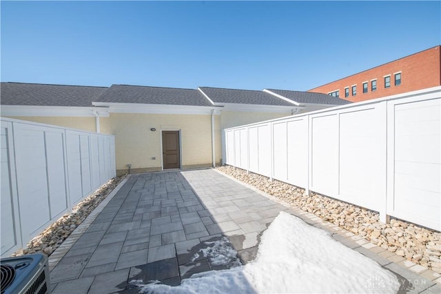 rear view of property with central AC and a patio area