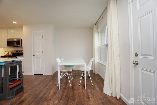 dining room with dark hardwood / wood-style flooring