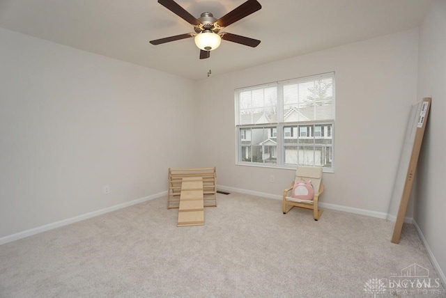 unfurnished room with light colored carpet and ceiling fan