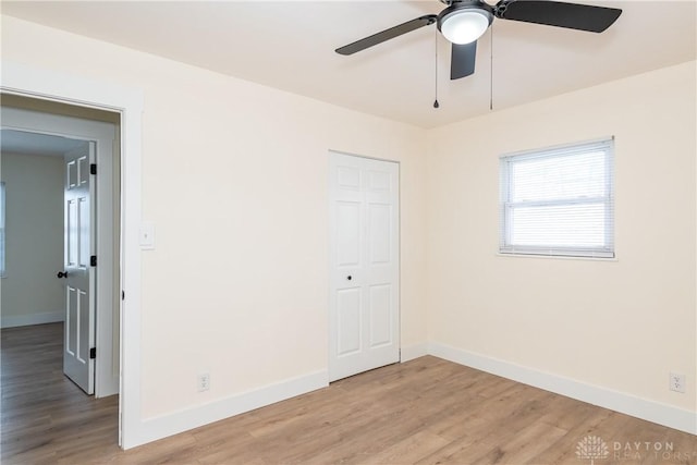 empty room with light hardwood / wood-style flooring and ceiling fan