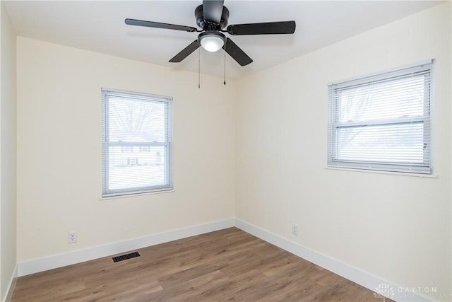 unfurnished room with hardwood / wood-style flooring and ceiling fan