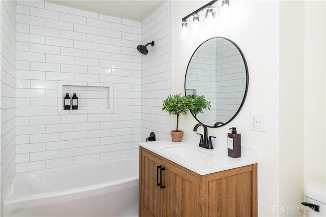 full bathroom with toilet, vanity, and tiled shower / bath