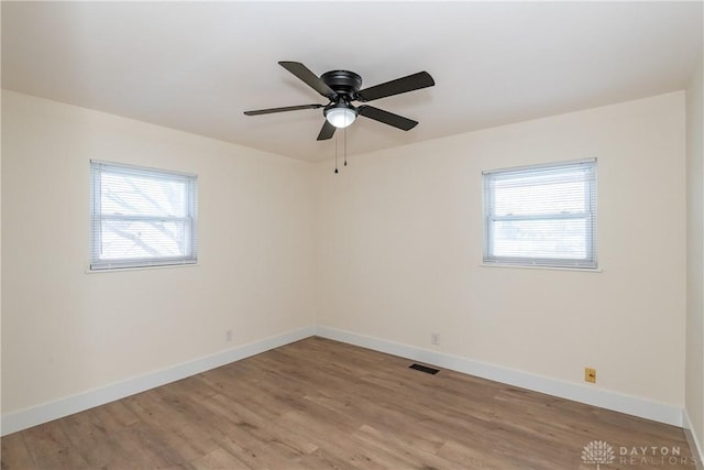 unfurnished room featuring light hardwood / wood-style floors, plenty of natural light, and ceiling fan