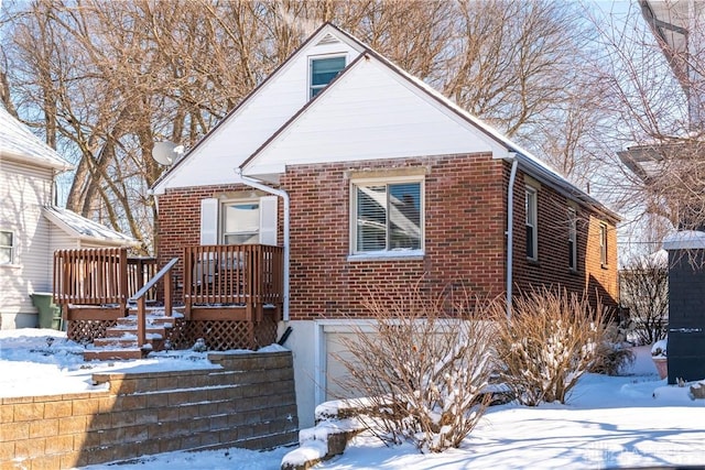 view of front of house with a garage and brick siding