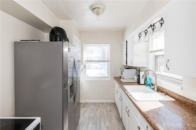 1908 John Glenn Rd, Dayton, OH 45420 - kitchen featuring open shelves, stainless steel fridge, a sink, a textured ceiling, and white cabinetry