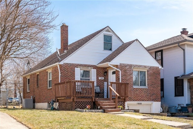 1908 John Glenn Rd, Dayton, OH 45420 - bungalow-style home with brick siding, central AC, a chimney, and a front lawn