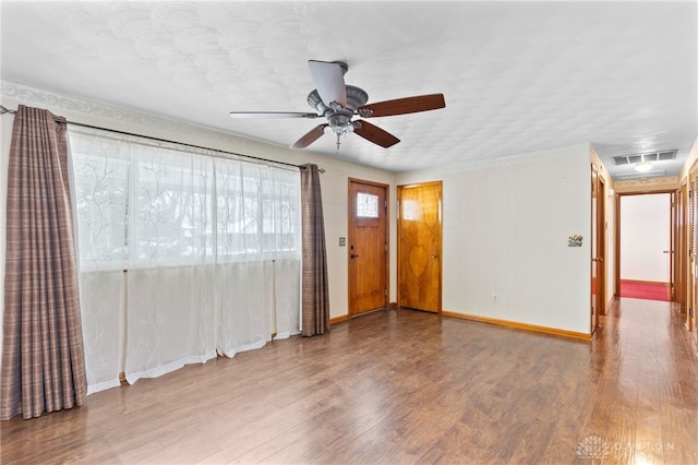 empty room featuring hardwood / wood-style floors and ceiling fan