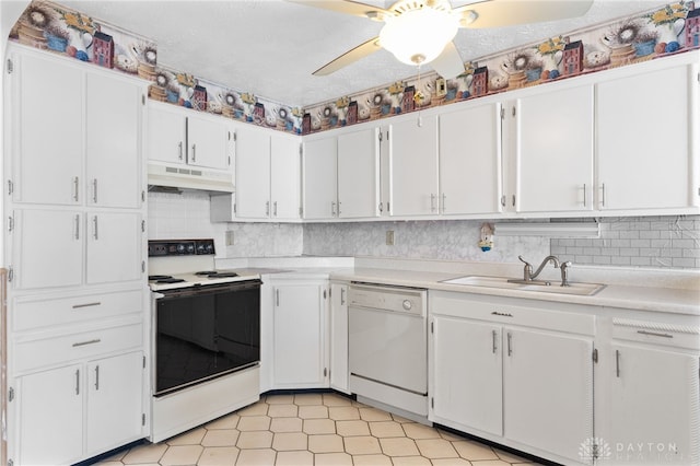 kitchen featuring white appliances, white cabinets, ceiling fan, decorative backsplash, and sink