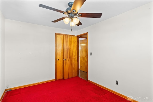 spare room featuring carpet flooring and ceiling fan