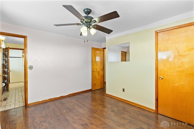 empty room featuring dark hardwood / wood-style floors and ceiling fan