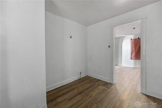 spare room featuring dark wood-type flooring
