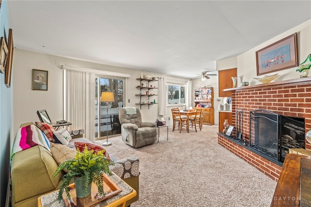 carpeted living room with a brick fireplace and ceiling fan