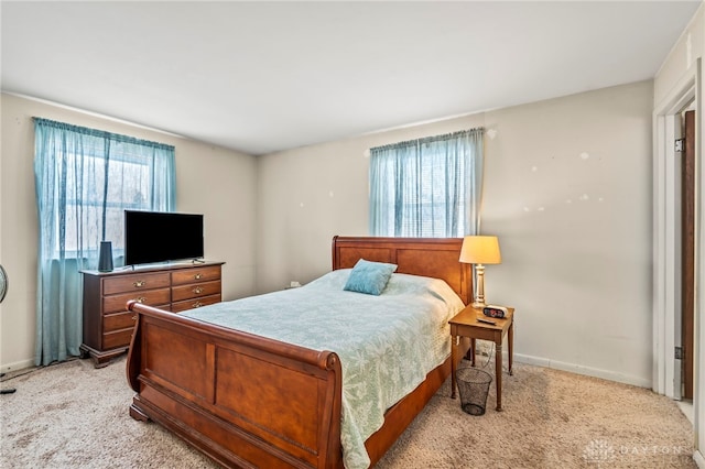 bedroom featuring light carpet