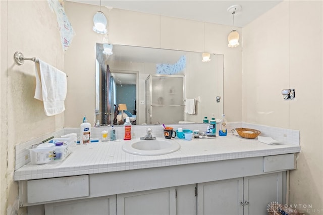 bathroom with vanity and a shower with door